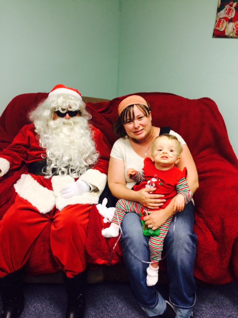 Blind Santa with a mother and her baby